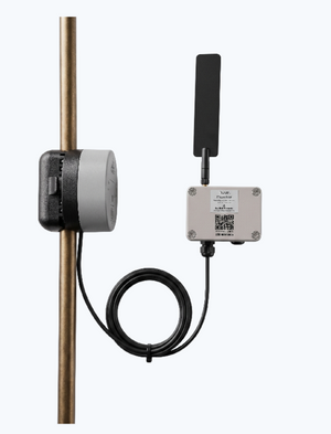 A NOWi Battery-Powered Pipe Monitor clamped onto a copper pipe